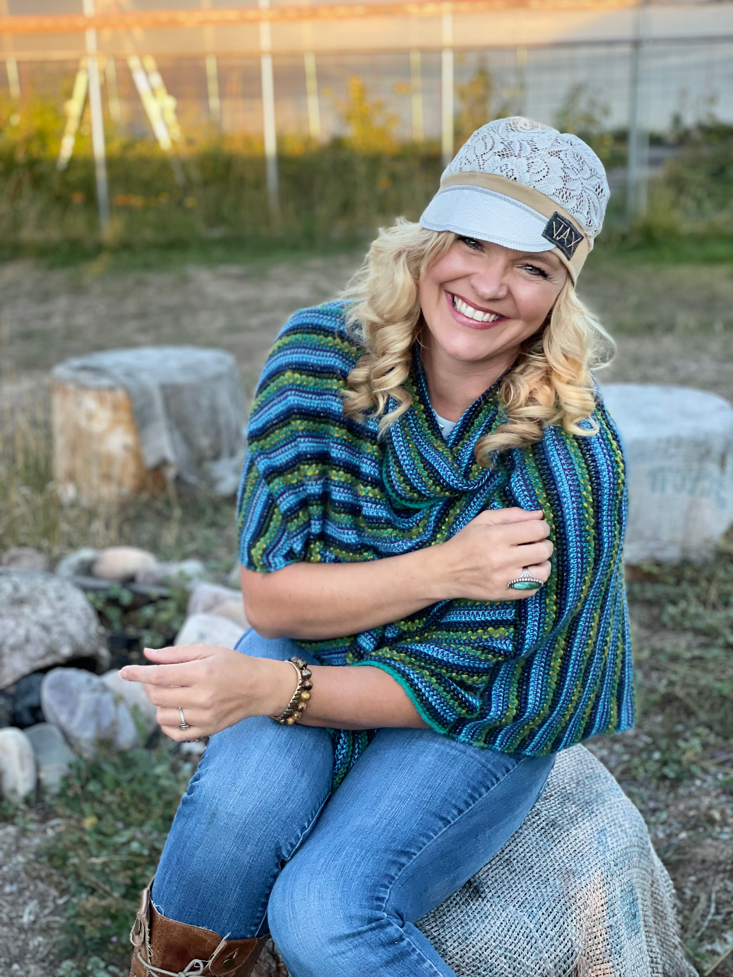Lady with lace hat with decorative band sitting on a rock