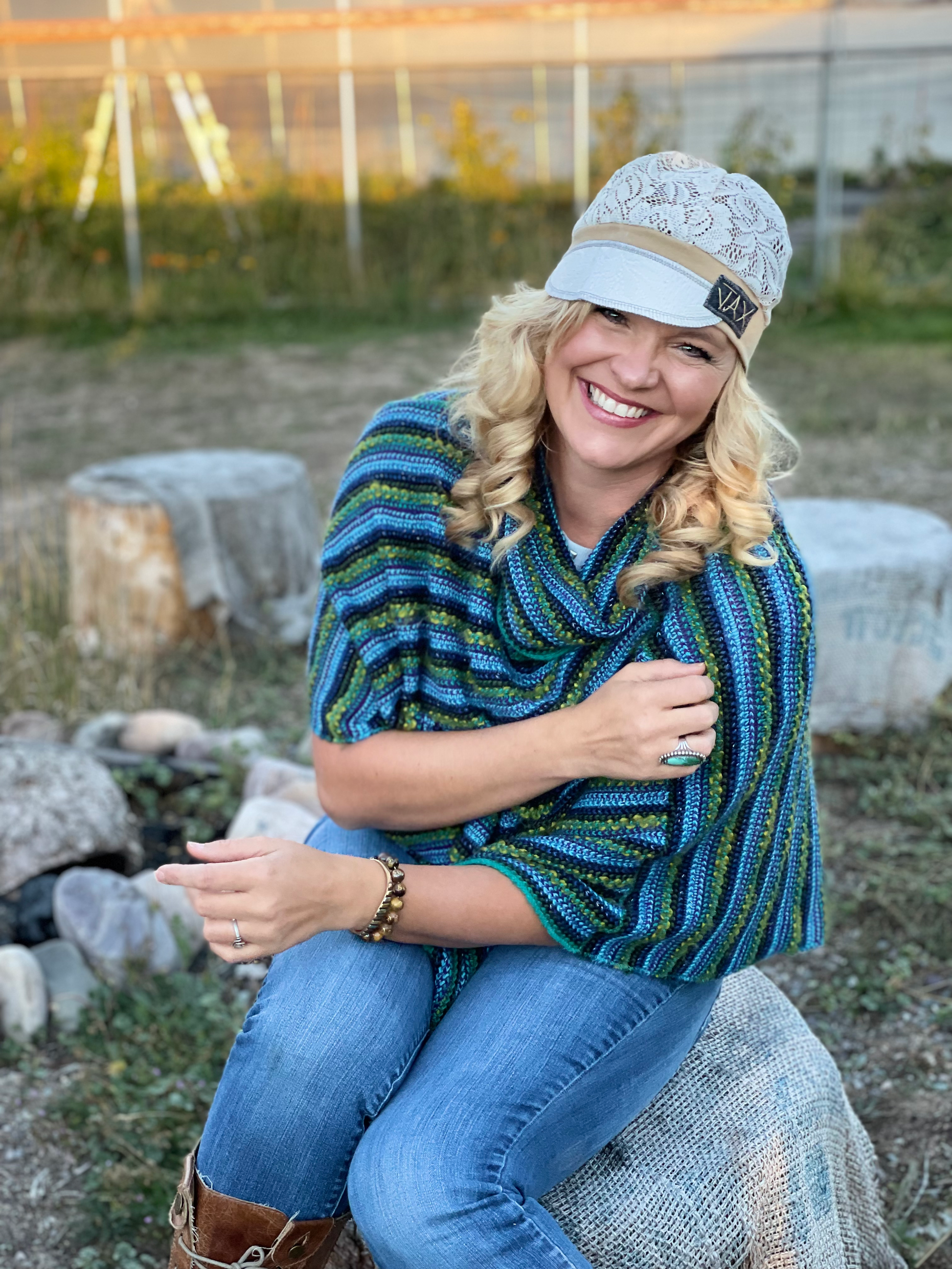 Lady with lace hat with decorative band sitting on a rock