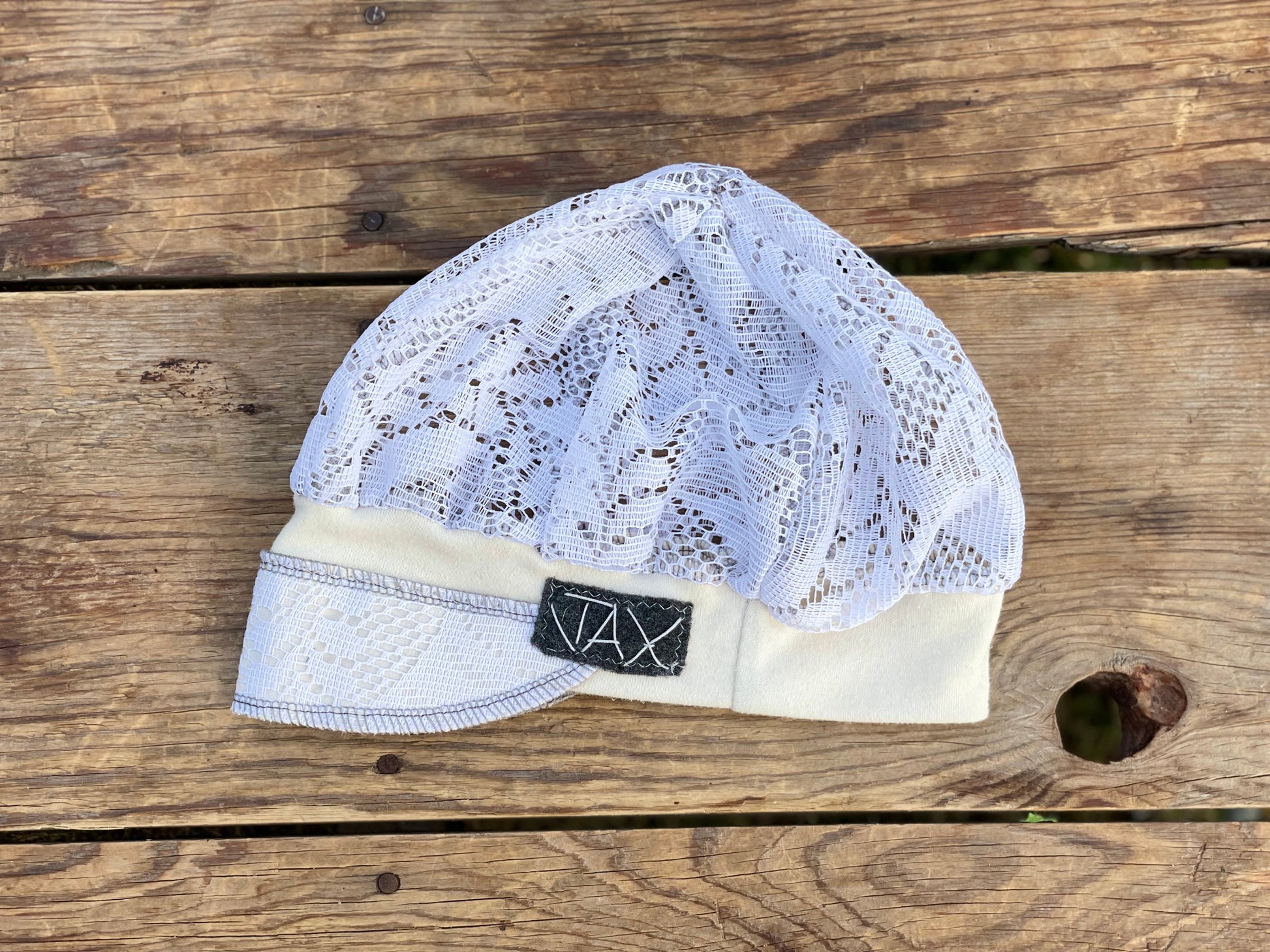 Upcycled Lace curtain into a cream hat on wooden table