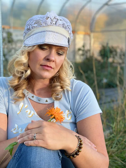 Lady in a lace hat in a garden with a merigold